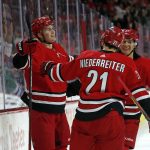 
              Carolina Hurricanes' Martin Necas, left, celebrates his goal with teammates Nino Niederreiter (21) and Ethan Bear (25) during the second period of an NHL hockey game against the Tampa Bay Lightning in Raleigh, N.C., Tuesday, March 22, 2022. (AP Photo/Karl B DeBlaker)
            