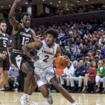 
              Virginia guard Reece Beekman (2) pushes around St. Bonaventure forward Abdoul Karim Coulibaly (12) during an NCAA college basketball game in the quarterfinals of the NIT, Tuesday, March 22, 2022, in Charlottesville, Va. (Erin Edgerton/The Daily Progress via AP)
            