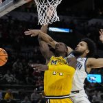 
              Villanova guard Caleb Daniels, right, fouls Michigan forward Moussa Diabate during the second half of a college basketball game in the Sweet 16 round of the NCAA tournament on Thursday, March 24, 2022, in San Antonio. (AP Photo/Eric Gay)
            