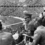 
              FILE - From left to right, Dr. Joseph Goebbels, German Chancellor Adolf Hitler, Reichs Sports Leader Hans von Tschammer und Osten and General Field Marschall Werner von Blomberg observe the Olympic Games in Berlin, Germany in August 1936. The International Olympic Committee has always been political, from the sheikhs and royals in its membership to a seat at the United Nations to pushing for peace talks between the Koreas. But Russia’s invasion of Ukraine three weeks ago exposed its irreconcilable claims of “political neutrality.” (AP Photo, File)
            