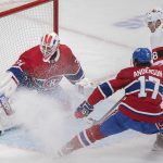 
              Montreal Canadiens goaltender Jake Allen stops Ottawa Senators' Tim Stutzle as Canadiens' Josh Anderson defends during the second period of an NHL hockey game Saturday, March 19, 2022, in Montreal. (Graham Hughes/The Canadian Press via AP)
            