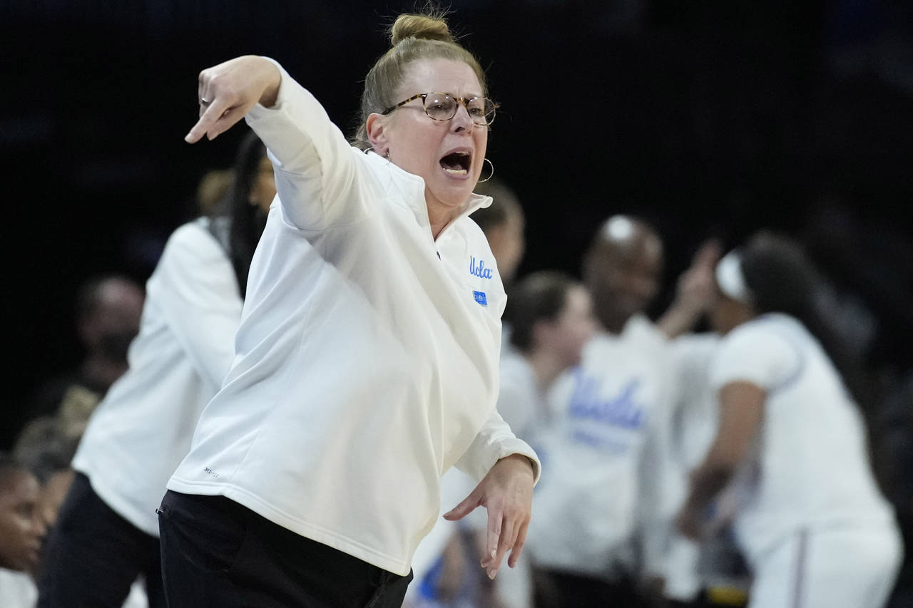 UCLA head coach Cori Close motions towards the court during the second half of an NCAA college bask...
