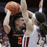 
              Oregon State guard Jarod Lucas, left, controls the ball while defended by Washington State guard Tyrell Roberts during the second half of an NCAA college basketball game, Thursday, March 3, 2022, in Pullman, Wash. Washington State won 71-67. (AP Photo/Young Kwak)
            