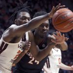 
              Virginia Tech's Justyn Mutts, left, and Louisville's Jae'Lyn Withers reach for a rebound during the first half of an NCAA college basketball game Tuesday, March 1, 2022, in Blacksburg, Va. (Matt Gentry/The Roanoke Times via AP)
            
