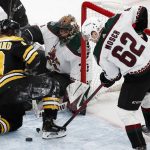
              Boston Bruins' Brad Marchand (63) battles Arizona Coyotes' J.J. Moser (62) for control of the puck in front of Coyotes goalie Karel Vejmelka during the first period of an NHL hockey game, Saturday, March 12, 2022, in Boston. (AP Photo/Michael Dwyer)
            