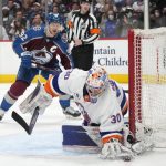 
              New York Islanders goaltender Ilya Sorokin, front, reaches out to stop the puck as Colorado Avalanche left wing Gabriel Landeskog watches during the third period of an NHL hockey game Tuesday, March 1, 2022, in Denver. (AP Photo/David Zalubowski)
            