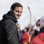
              Switzerland's Roger Federer walks in the finish area of an alpine ski, women's World Cup super-G, in Lenzerheide, Switzerland, Saturday, March 5, 2022. (AP Photo/Giovanni Auletta)
            