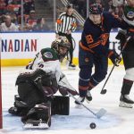
              Arizona Coyotes goalie Karel Vejmelka (70) makes a save as Edmonton Oilers' Zach Hyman (18) looks for the rebound during second-period NHL hockey game action in Edmonton, Alberta, Monday, March 28, 2022. (Jason Franson/The Canadian Press via AP)
            