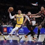 
              Los Angeles Lakers' Russell Westbrook (0) drives to the basket past Toronto Raptors' Scottie Barnes (4) during first half of an NBA basketball game Monday, March 14, 2022, in Los Angeles. (AP Photo/Jae C. Hong)
            