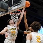 
              Wright State's Grant Basile (0) blocks a shot by Bryant guard Charles Pride (5) during the first half of a First Four game in the NCAA men's college basketball tournament, Wednesday, March 16, 2022, in Dayton, Ohio. (AP Photo/Jeff Dean)
            