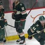 
              Minnesota Wild's Nicolas Deslauriers, right, skates out of the celebration circle after scoring his first goal as a new addition to the Wild roster off Vegas Golden Knights goalie Logan Thompson (36) in the first period of an NHL hockey game, Monday, March 21, 2022, in St. Paul, Minn. (AP Photo/Jim Mone)
            