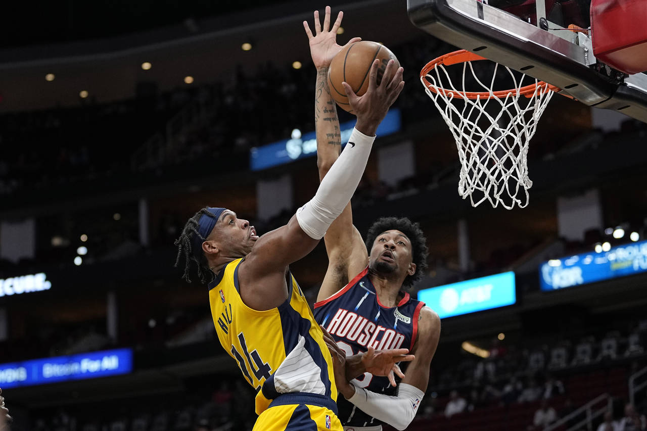 Indiana Pacers' Buddy Hield goes up for a shot as Houston Rockets' Christian Wood defends during th...