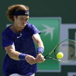 
              Andrey Rublev, of Russia, returns a shot to Taylor Fritz during the men's singles semifinals at the BNP Paribas Open tennis tournament Saturday, March 19, 2022, in Indian Wells, Calif. (AP Photo/Marcio Jose Sanchez)
            