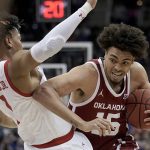 
              Oklahoma forward Ethan Chargois (15) tries to get around Texas Tech guard Terrence Shannon Jr. (1) during the first half of an NCAA college basketball game in the semifinal round of the Big 12 Conference tournament in Kansas City, Mo., Friday, March 11, 2022. (AP Photo/Charlie Riedel)
            