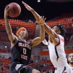 
              Oklahoma State guard Avery Anderson III (0) goes to the basket past Texas Tech guard Terrence Shannon Jr. (1) in the second half of an NCAA college basketball game Saturday, March 5, 2022, in Stillwater, Okla. (AP Photo/Sue Ogrocki)
            