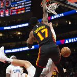 
              Atlanta Hawks forward Onyeka Okongwu (17) dunks over Los Angeles Clippers center Ivica Zubac during the second half of an NBA basketball game Friday, March 11, 2022, in Atlanta. (AP Photo/Hakim Wright Sr.)
            