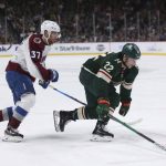 
              Minnesota Wild left wing Kevin Fiala (22) handles the puck against Colorado Avalanche left wing J.T. Compher (37) during the second period of an NHL hockey game Sunday, March 27, 2022, in St. Paul, Minn. (AP Photo/Stacy Bengs)
            