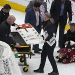 
              A stretcher is brought out for Arizona Coyotes' Clayton Keller (9) after he crashed into the boards during the third period of the team's NHL hockey game against the San Jose Sharks, Wednesday, March 30, 2022, in Glendale, Ariz. (AP Photo/Darryl Webb)
            