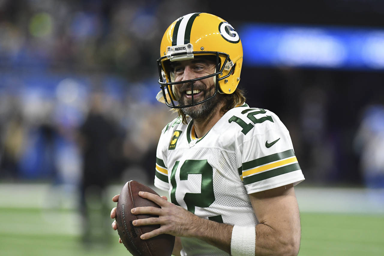 FILE - Green Bay Packers quarterback Aaron Rodgers smiles during pregame of an NFL football game ag...