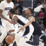 
              Memphis Grizzlies' De'Anthony Melton, front right, defends against Orlando Magic's Terrence Ross, front left, in the first half of an NBA basketball game Saturday, March 5, 2022, in Memphis, Tenn. (AP Photo/Karen Pulfer Focht)
            