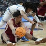 
              Washington State's DJ Rodman (11) passes around UCLA's Tyger Campbell (10) during the first half of an NCAA college basketball game in the quarterfinal round of the Pac-12 tournament Thursday, March 10, 2022, in Las Vegas. (AP Photo/John Locher)
            