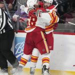 
              Calgary Flames defenseman Oliver Kylington, front, celebrates with left wing Johnny Gaudreau, who scored in overtime against the Colorado Avalanche during an NHL hockey game Saturday, March 5, 2022, in Denver. The Flames won 4-3. (AP Photo/David Zalubowski)
            