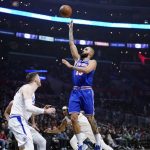 
              New York Knicks guard Evan Fournier (13) shoots over Los Angeles Clippers center Isaiah Hartenstein, left, during the first half of an NBA basketball game Sunday, March 6, 2022, in Los Angeles. (AP Photo/Marcio Jose Sanchez)
            