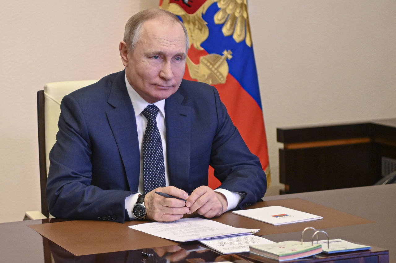 Russian President Vladimir Putin takes part in the launch of a new ferry via a conference call at t...