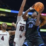 
              Kentucky's Rhyne Howard, right, drives against South Carolina's Kamilla Cardoso, center, and Aliyah Boston (4) in the first half of the NCAA women's college basketball Southeastern Conference tournament championship game Sunday, March 6, 2022, in Nashville, Tenn. (AP Photo/Mark Humphrey)
            