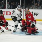 
              Chicago Blackhawks goaltender Collin Delia (60) stops a shot by Los Angeles Kings left wing Viktor Arvidsson (33) during the second period of an NHL hockey game Thursday, March 24, 2022, in Los Angeles. Chicago Blackhawks defenseman Erik Gustafsson (56) defends. (AP Photo/Ashley Landis)
            
