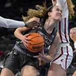 
              Utah forward Jenna Johnson (22) drives to the basket against Washington State during the second half of an NCAA college basketball game in the quarterfinals of the Pac-12 women's tournament Thursday, March 3, 2022, in Las Vegas. (AP Photo/David Becker)
            