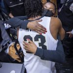 
              Niele Ivey, front right, mother of Purdue guard Jaden Ivey (23), greets her son at courtside after the team defeated Rutgers in an NCAA college basketball game, Sunday, Feb. 20, 2022, in West Lafayette, Ind. (AP Photo/Doug McSchooler)
            