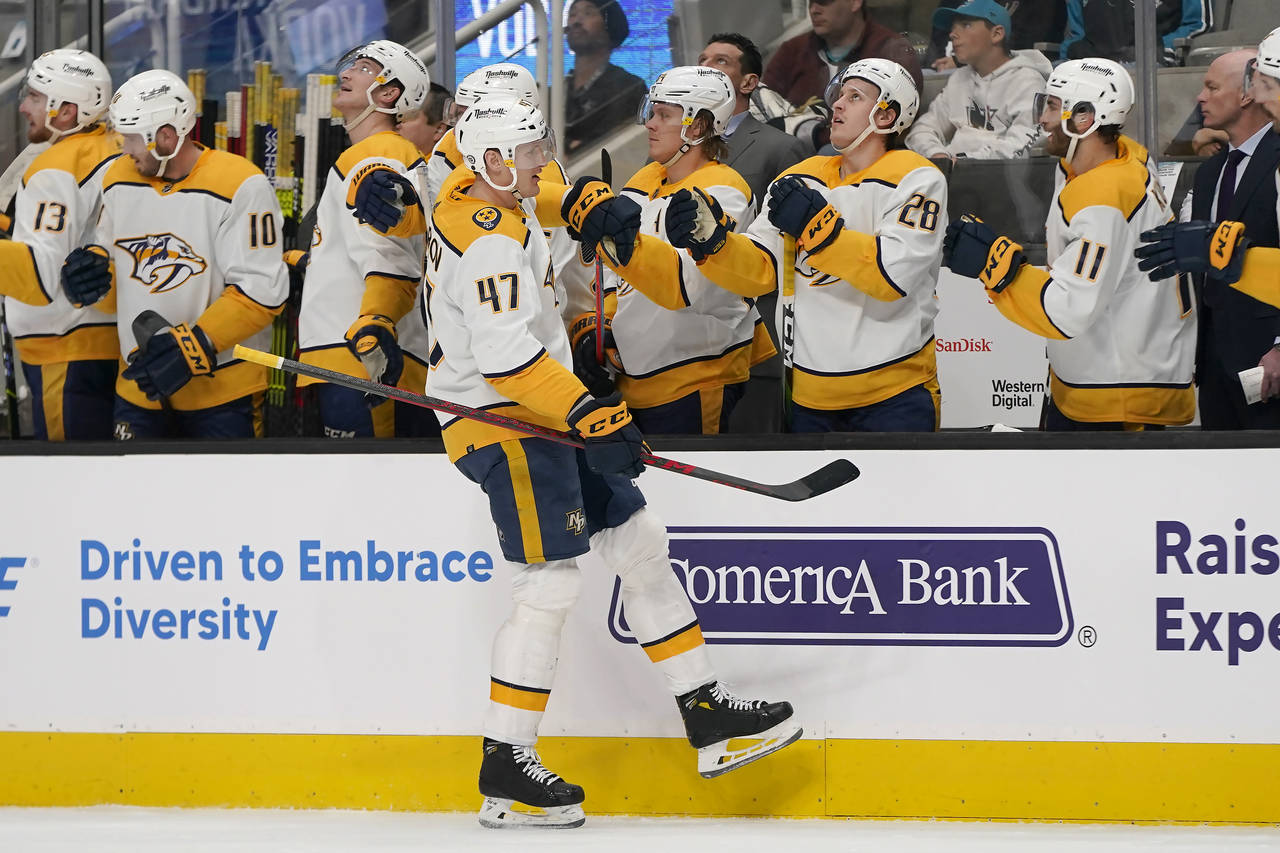 Nashville Predators right wing Michael McCarron (47) is congratulated by teammates after scoring ag...