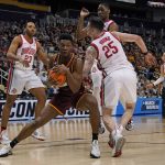 
              Loyola of Chicago's Chris Knight, center left, attempts to get off a shot with Ohio State 's Kyle Young (25) defending during the first half of a college basketball game in the first round of the NCAA tournament in Pittsburgh, Friday, March 18, 2022. (AP Photo/Gene J. Puskar)
            