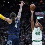 
              Boston Celtics center Al Horford (42) takes a shot over Memphis Grizzlies center Steven Adams (4) during the second half of an NBA basketball game, Thursday, March 3, 2022 in Boston. The Celtics defeated the Grizzlies 120-107. (AP Photo/Charles Krupa)
            
