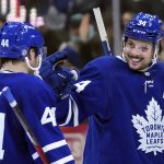 
              Toronto Maple Leafs forward Auston Matthews (34) celebrates his hat trick with teammate Morgan Rielly (44) during the third period of an NHL hockey game against the Seattle Kraken, Tuesday, March 8, 2022, in Toronto. (Nathan Denette/The Canadian Press via AP)
            