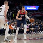 
              Washington Wizards center Kristaps Porzingis (6) is defended by Denver Nuggets center Nikola Jokic (15) during the first half of an NBA basketball game, Wednesday, March 16, 2022, in Washington. (AP Photo/Evan Vucci)
            