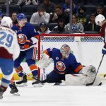 
              Colorado Avalanche center Nathan MacKinnon (29) has a shot stopped by New York Islanders goaltender Semyon Varlamov (40) as Avalanche right wing Mikko Rantanen (96) looks for a rebound during the second period of an NHL hockey game on Monday, March 7, 2022, in Elmont, N.Y. (AP Photo/Jim McIsaac)
            