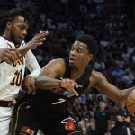 
              Miami Heat guard Kyle Lowry (7) looks to pass the ball as Cleveland Cavaliers guard Tim Frazier (10) defends during the second half of an NBA basketball game, Friday, March 11, 2022, in Miami. (AP Photo/Marta Lavandier)
            