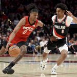 
              Houston Rockets guard Jalen Green, left, drives to the basket on Portland Trail Blazers guard Keon Johnson, right, during the first half of an NBA basketball game in Portland, Ore., Saturday, March 26, 2022.(AP Photo/Steve Dykes)
            