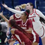 
              Georgia's Jenna Staiti (14) reaches over Alabama's Brittany Davis in the first half of an NCAA college basketball game at the women's Southeastern Conference tournament Thursday, March 3, 2022, in Nashville, Tenn. (AP Photo/Mark Humphrey)
            