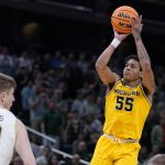 
              Michigan guard Eli Brooks (55) shoots over Colorado State forward James Moors (10) during the second half of a college basketball game in the first round of the NCAA tournament in Indianapolis, Thursday, March 17, 2022. (AP Photo/Michael Conroy)
            