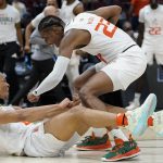 
              Miami's Isaiah Wong is conratulated by Kameron McGusty (23) after making a shot and being fouled during the second half of a college basketball game in the Sweet 16 round of the NCAA tournament Friday, March 25, 2022, in Chicago. (AP Photo/Nam Y. Huh)
            