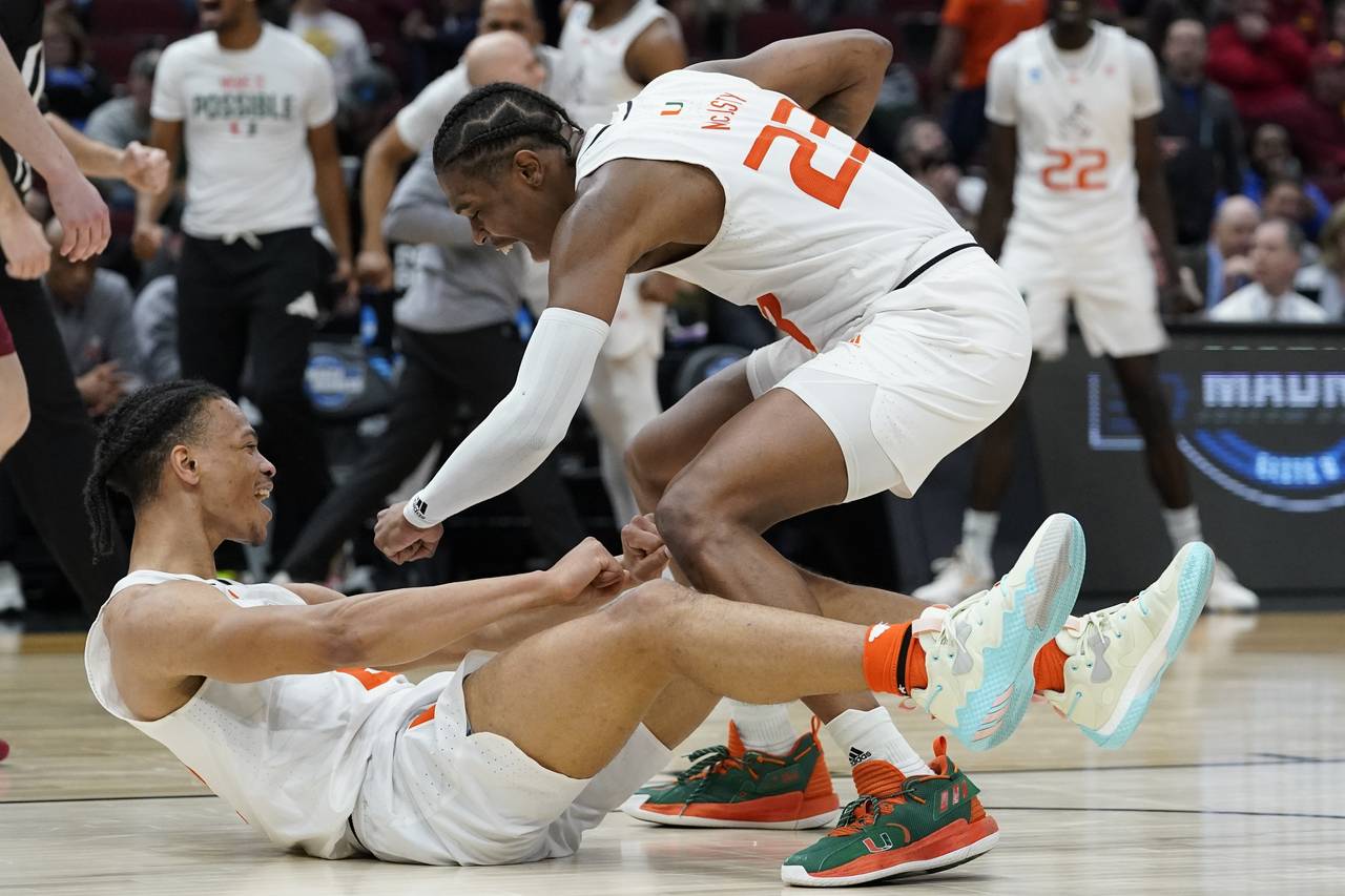 Miami's Isaiah Wong is conratulated by Kameron McGusty (23) after making a shot and being fouled du...