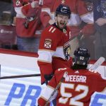 
              Florida Panthers left wing Jonathan Huberdeau (11) celebrates a goal with teammate defenseman MacKenzie Weegar (52) during the first period of an NHL hockey game against the Montreal Canadiens Tuesday, March 29, 2022, in Sunrise, Fla. (AP Photo/Jim Rassol)
            