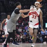 
              Toronto Raptors guard Gary Trent Jr. (33) passes the ball away from Brooklyn Nets guard Seth Curry (30) during the first half of an NBA basketball game Tuesday, March 1, 2022, in Toronto. (Nathan Denette/The Canadian Press via AP)
            