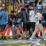 
              Fans clash during a Mexican soccer league match between the host Queretaro and Atlas from Guadalajara, at the Corregidora stadium, in Queretaro, Mexico, Saturday, March 5, 2022. Multiple people were injured during the brawl, including two critically.  (AP Photo/Sergio Gonzalez)
            