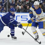 
              Toronto Maple Leafs forward John Tavares (91) battles for the puck against Buffalo Sabres forward Cody Eakin (20) during the second period of an NHL hockey game Wednesday, March 2, 2022 in Toronto. (Nathan Denette/The Canadian Press via AP)
            