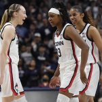 
              Connecticut's Paige Bueckers, left, Christyn Williams, center, and Evina Westbrook react during the second half of a second-round women's college basketball game against Central Florida in the NCAA tournament, Monday, March 21, 2022, in Storrs, Conn. (AP Photo/Jessica Hill)
            