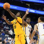 
              Missouri guard Kaleb Brown (13) gets between LSU forward Darius Days (4) and guard Xavier Pinson (1) for a shot during the second half of an NCAA college basketball game at the Southeastern Conference tournament in Tampa, Fla., Thursday, March 10, 2022. (AP Photo/Chris O'Meara)
            